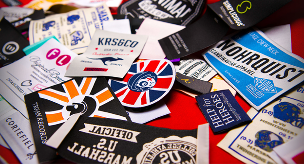 Lots of different woven labels on a desk